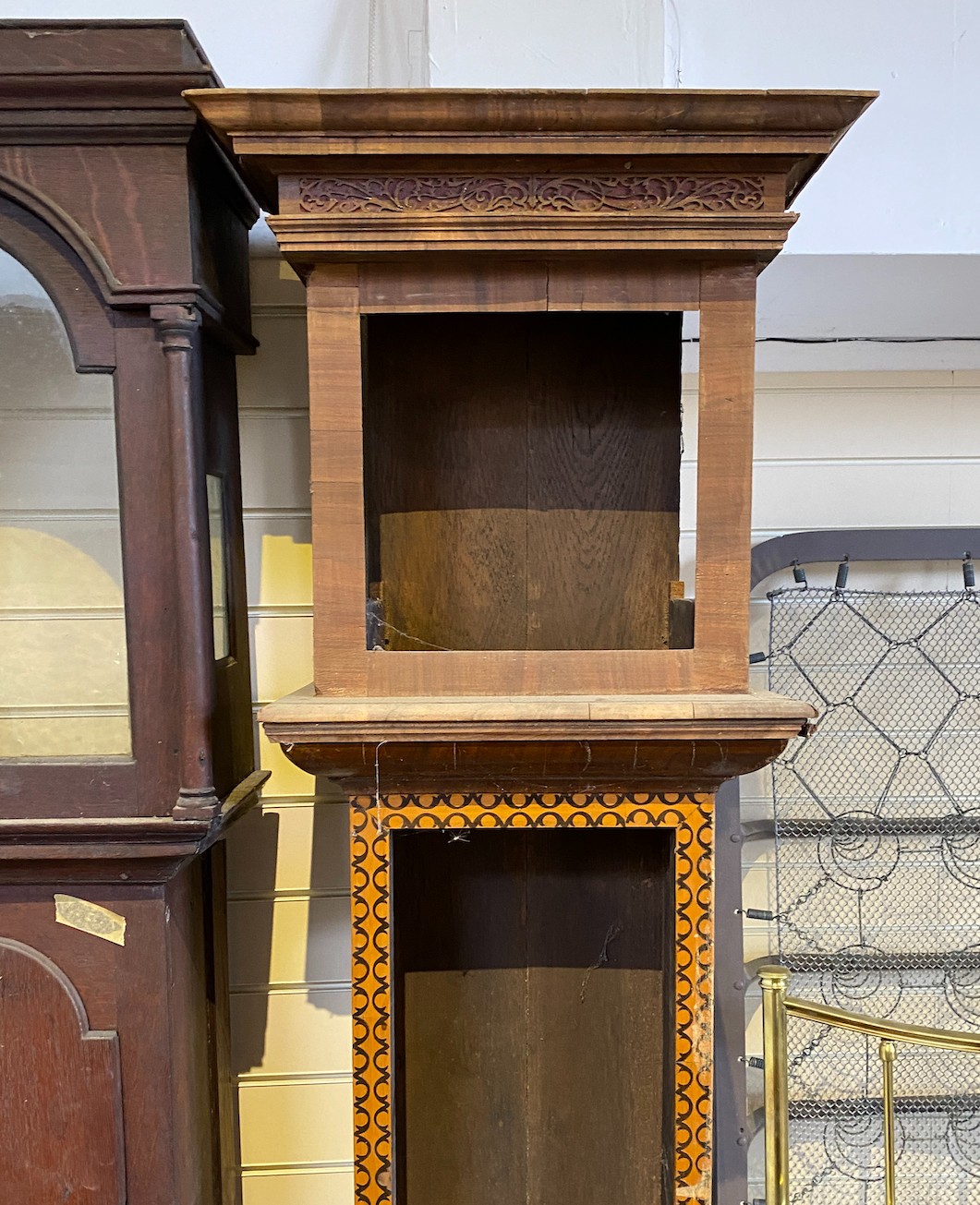 A George III oak longcase clock case and an inlaid clock case, larger 222 cm high.